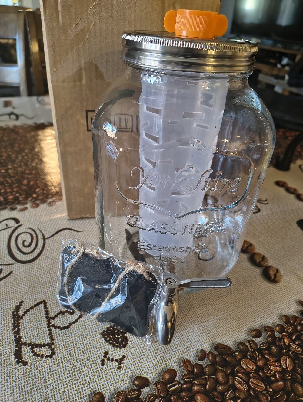 Glass Beverage Dispenser with Orange Infuser Lid and Silver Spigot
